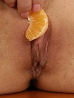 Teenage brunette cutie playing with this sticky mandarine